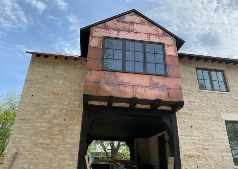 Copper metal panel facade on a stone building for Metal Roof Coating in Enid