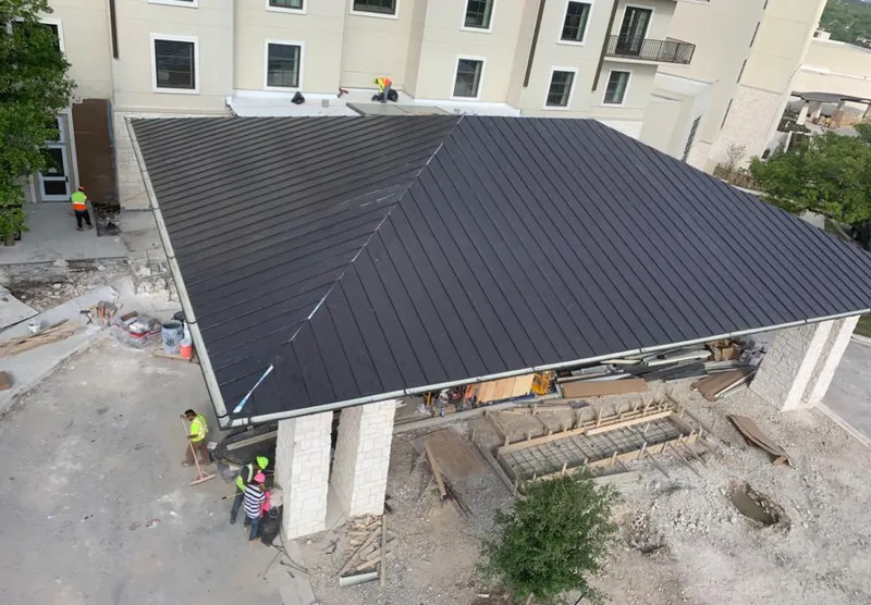 Metal roofing installation team working on a commercial building in Enid